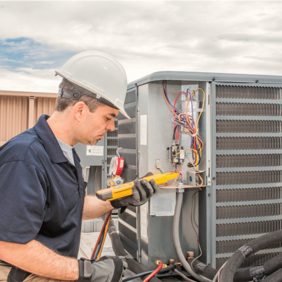 Milton Heating & Cooling HVAC technician servicing a system